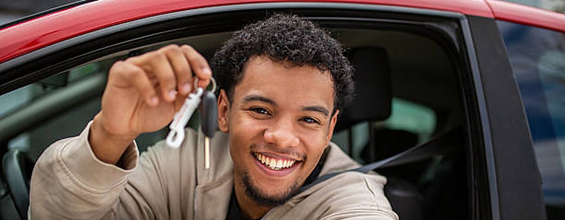 Happy driver holding up car keys